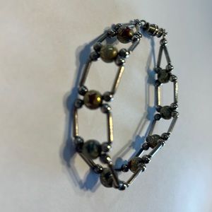 Silver bracelet with unique beads and balls.